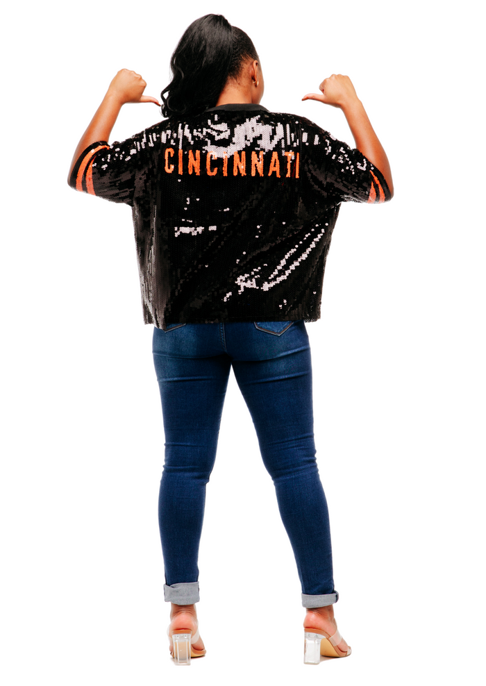 Model wearing a black Cincinnati sequin shirt with jeans